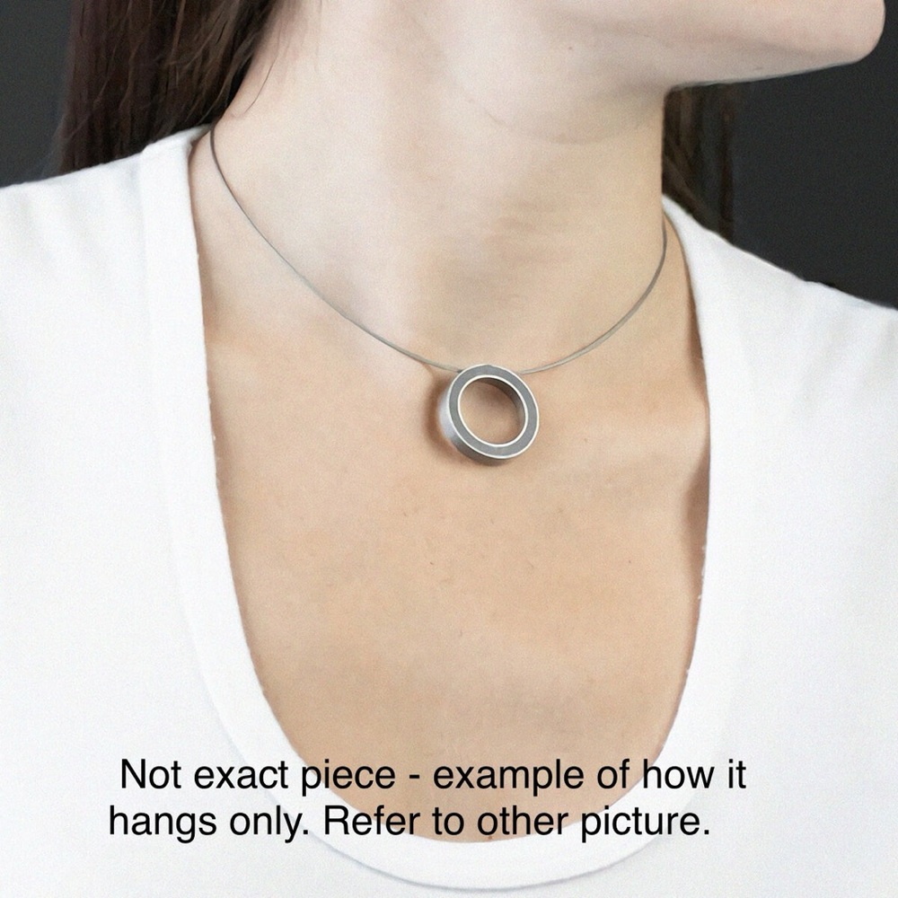 Brushed stainless steel pendant, fits a wire style necklace. Fuchsia interior